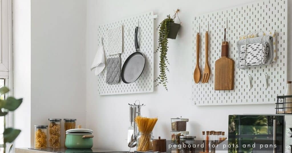 Kitchen tools and utensils hung on pegboard in a white kitchen