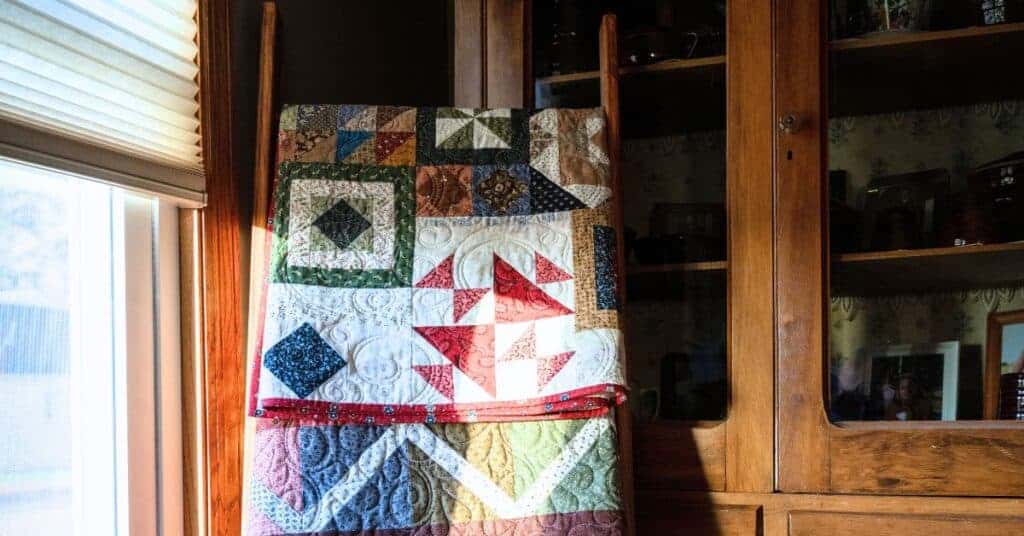 Quilt rack leaning in a corner of a bedroom