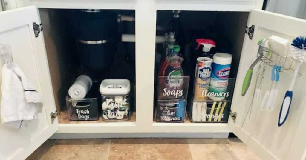 Stacked storage bins under a kitchen sink