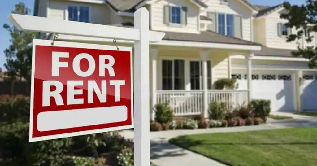 House with for rent sign posted in front yard