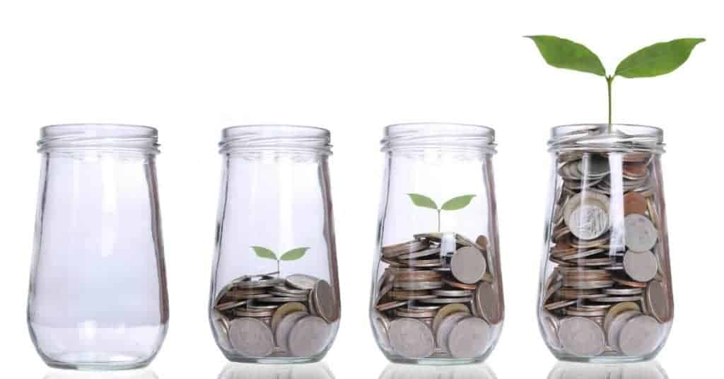 4 jars lined up, each with more coins inside, the last with plant growing - how you can save just $50 a month