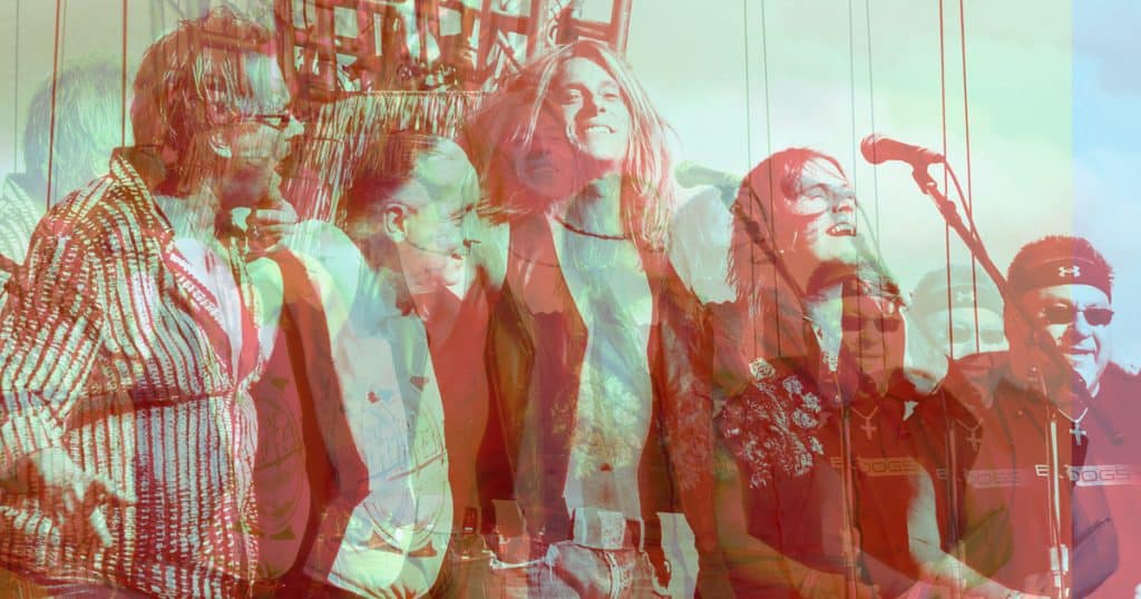 Music performance at Hypebot music industry event with diverse artists singing into microphones at outdoor festival for music industry news and analysis.