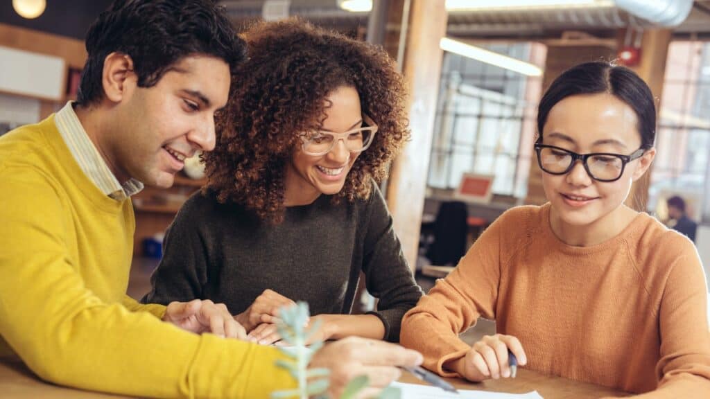 A Group Discussing at a Table with Paperwork