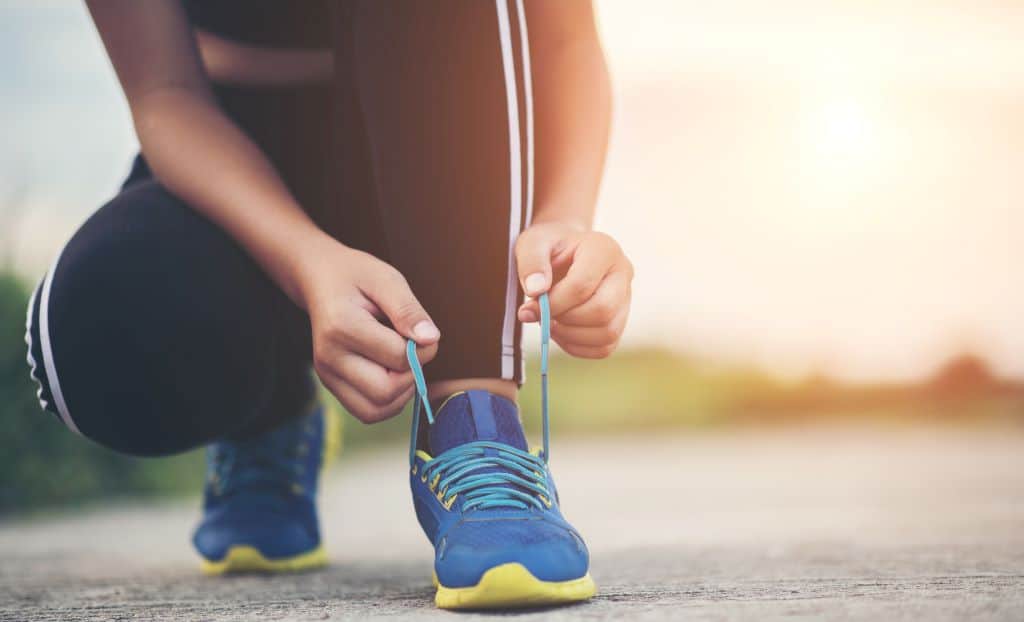 runner tying her shoes for a jogging exercise