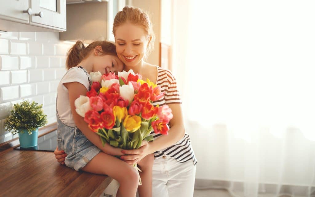 Mother and daughter celebrating Mothers Day in clean home
