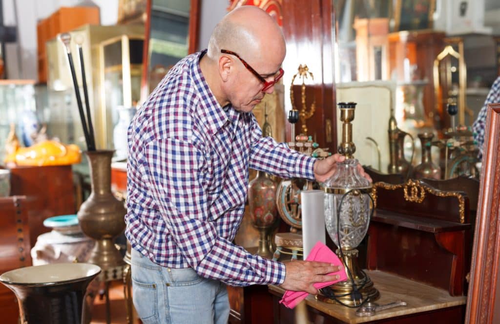 Professional dusting and cleaning delicate antique items