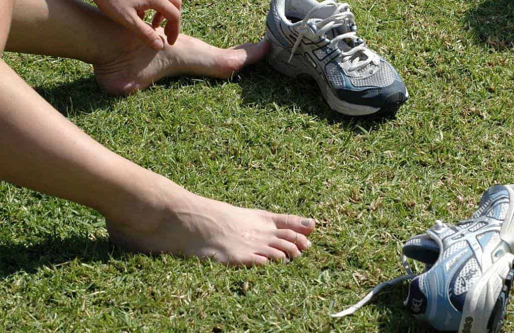 person barefoot sitting on the ground