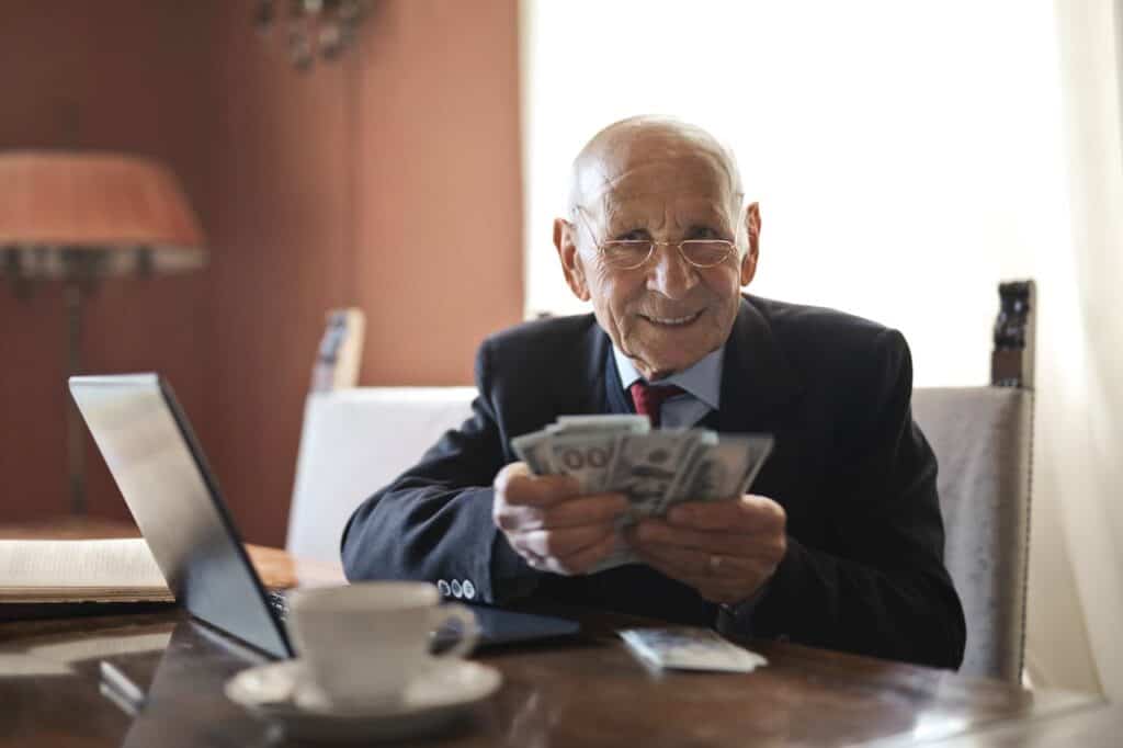 Boosting Your Credit Score - Man Counting Money