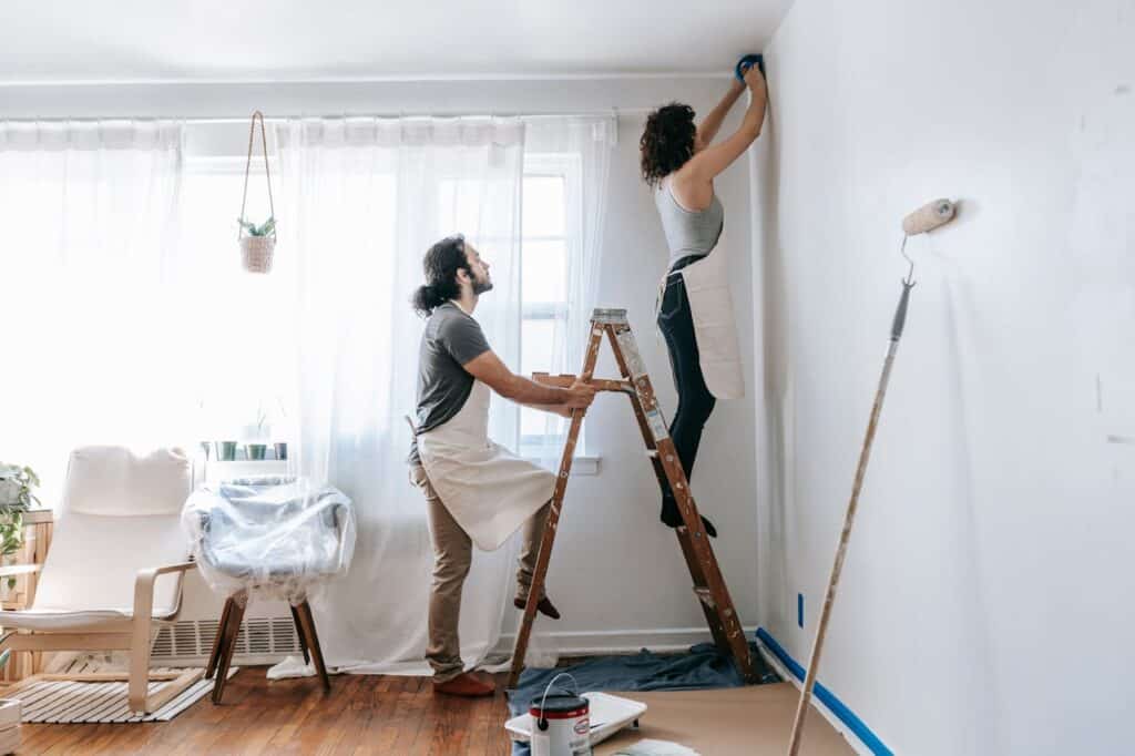 a couple painting the walls