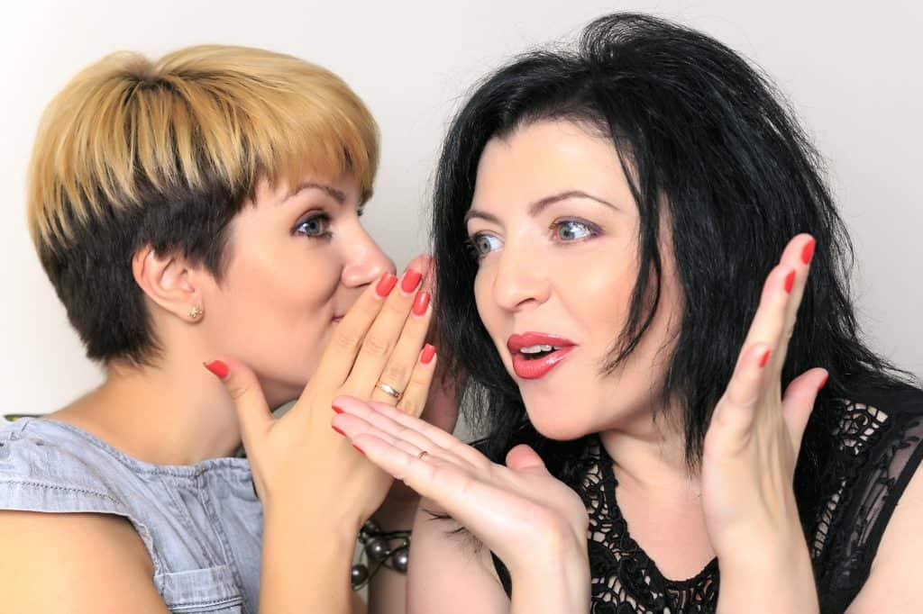 Women whispering about the secrets to finding true love.