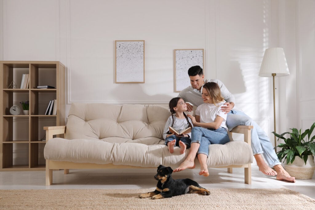 happy young family of three with their pet dog