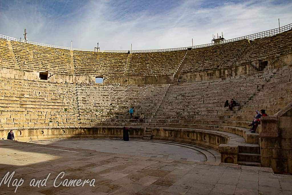 Interior view of the grand Roman amphitheater in Jerash, Jordan, with its well-preserved stone seating and open sky, a must-see attraction featured in top Jordan itineraries.