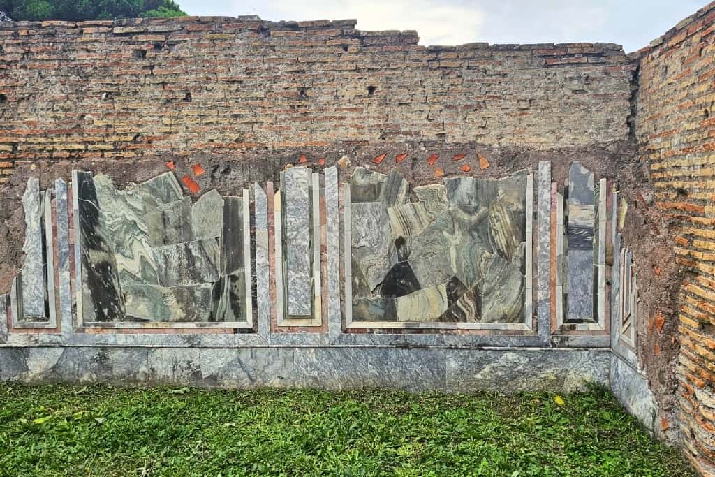 Marble-decorated walls in Ostia Antica, showcasing exquisite Roman craftsmanship.