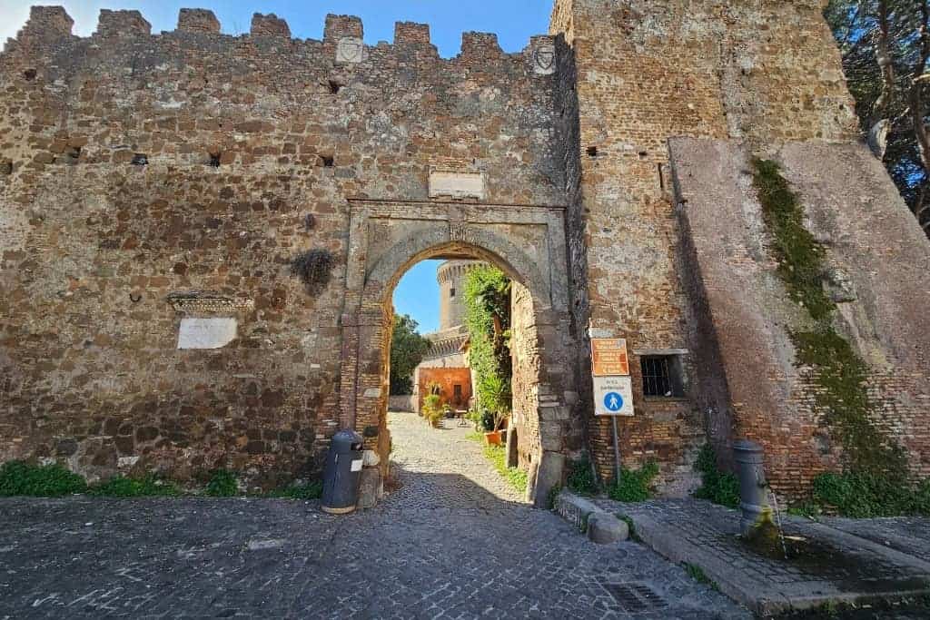 Historic stone gateway of Borgo di Ostia Antica, a charming medieval village next to the ancient ruins of Ostia Antica in Italy.