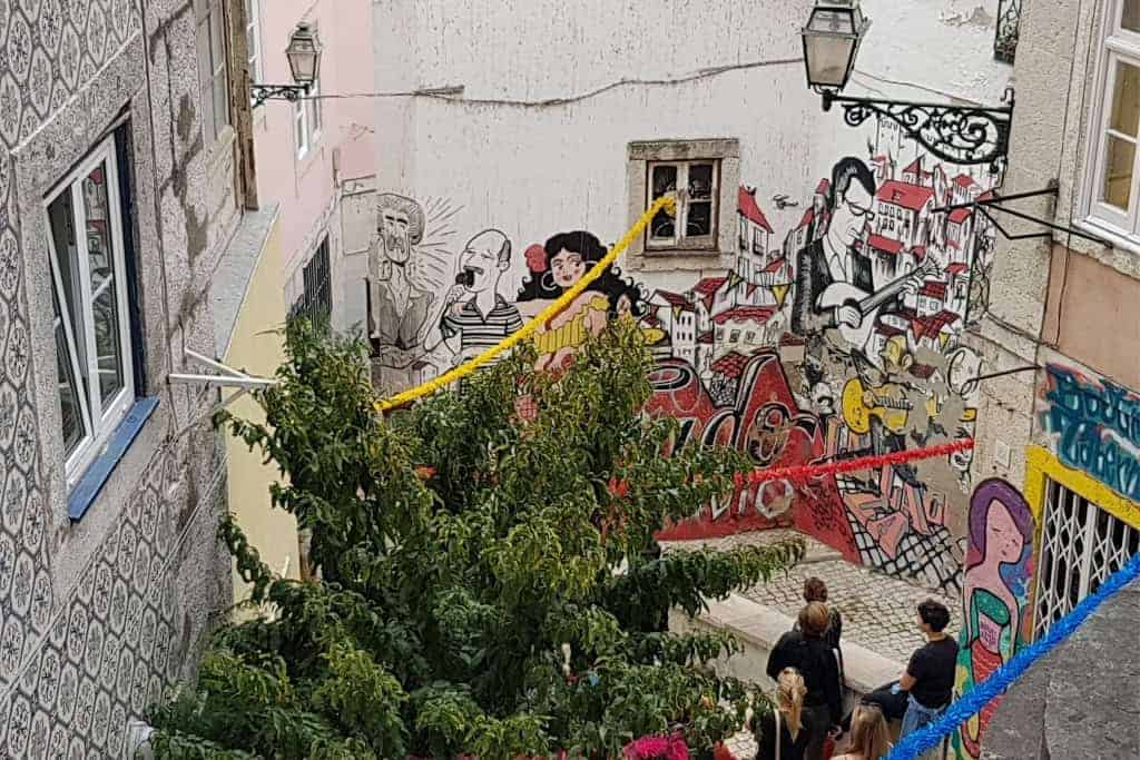 Vibrant street art in Lisbon’s historic neighborhoods, featuring murals of Fado musicians and urban culture. One of the best photo spots in Lisbon for street art lovers.