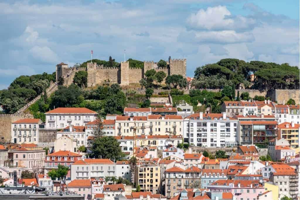 Castle São Jorge, seen from Miradouro de São Pedro de Alcântara, Lisbon – Scenic view of São Jorge Castle overlooking Lisbon's red-roofed buildings, a highlight on any walking route through the city.