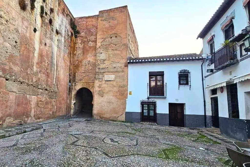 Historic Arco de las Pesas in Plaza Larga, Granada – a lesser-known Moorish gateway in the Albaicín, perfect for travelers exploring off-the-beaten-path sites in Granada.