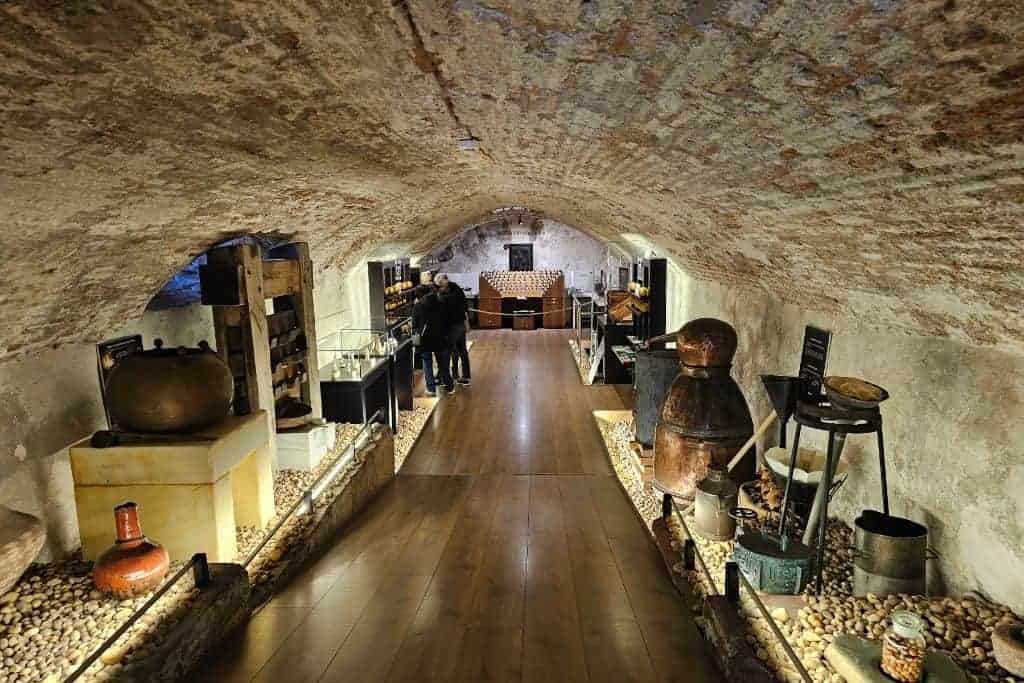 Historic perfume-making equipment in the cellar museum of Patio de los Perfumes in Granada – a hidden museum that showcases centuries of perfume history and artisanal craft.