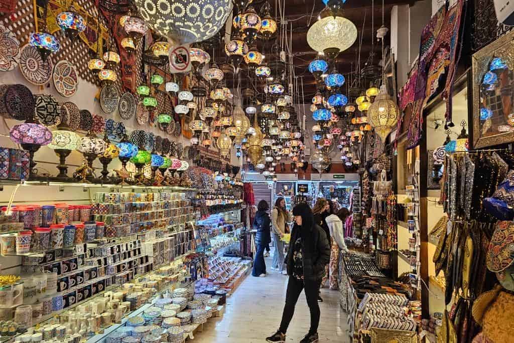 Colorful Moorish lamps and traditional Andalusian ceramics displayed in the vibrant Alcaicería Market in Granada, Spain – a must-visit for unique souvenirs and local handicrafts.