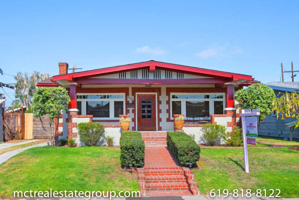 historic craftsman home in north park san diego- white house with red trim and grass in the front