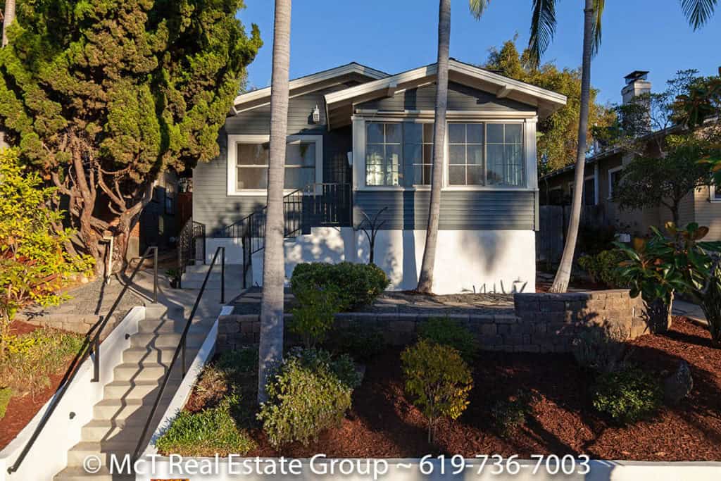 Charming blue Craftsman-style home with a sunroom and tiered landscaping at 3629 Villa Terrace in North Park.
