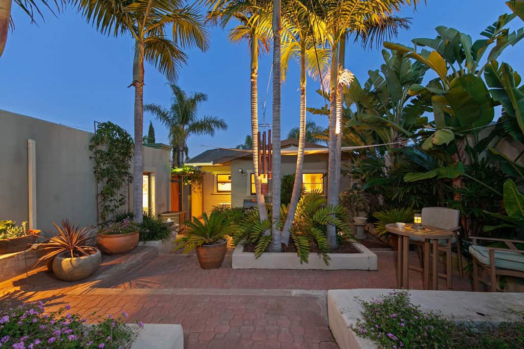north park bungalow backyard with palm trees and mature landscaping