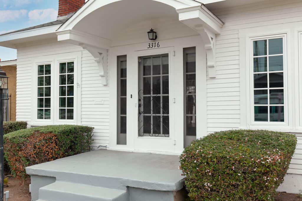 exterior front of a white north park bungalow