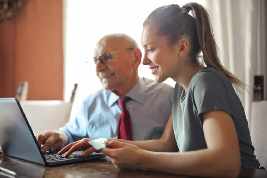 Boosting Your Credit Score - Girl with Credit Card Checking Things on Computer