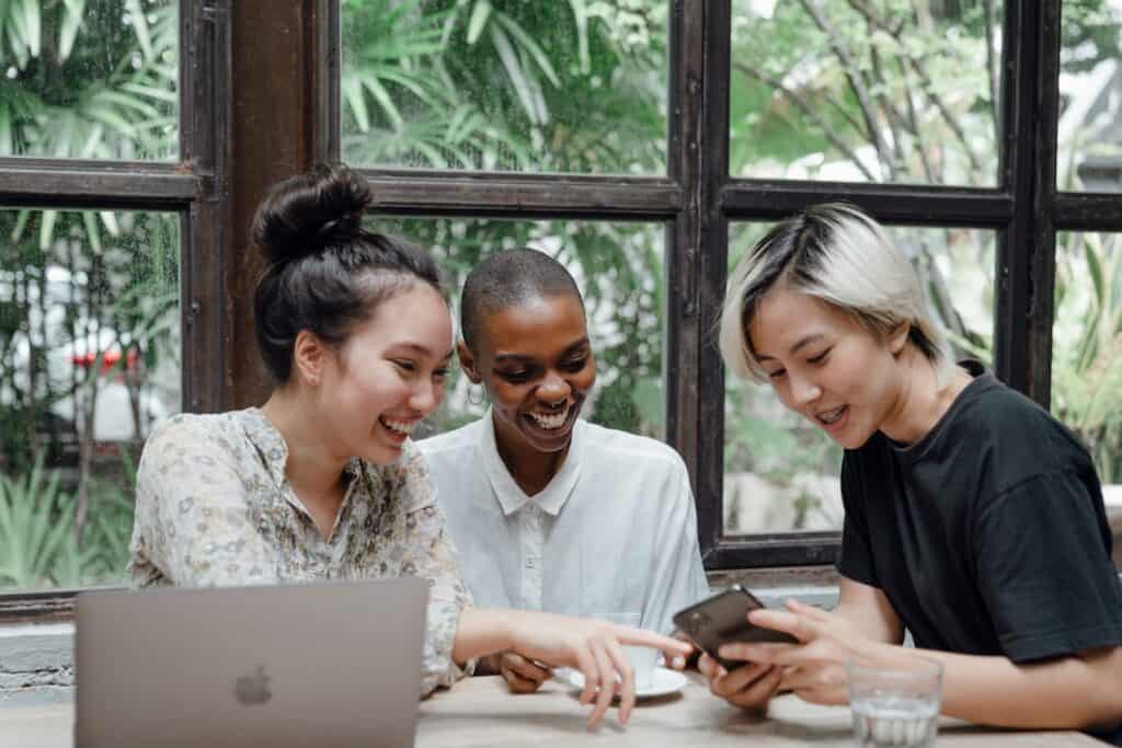 A Group of Friends Happily Talking at a Cafe
