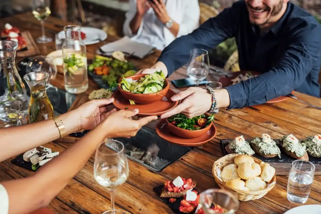 People at a Dining Table Sharing Food