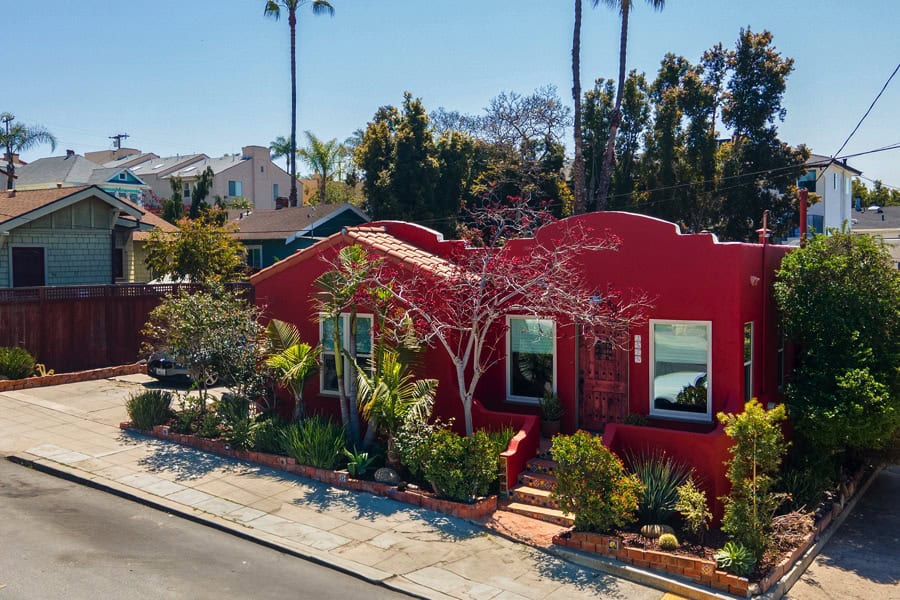 drone shot of brick colored Spanish Style Bungalow