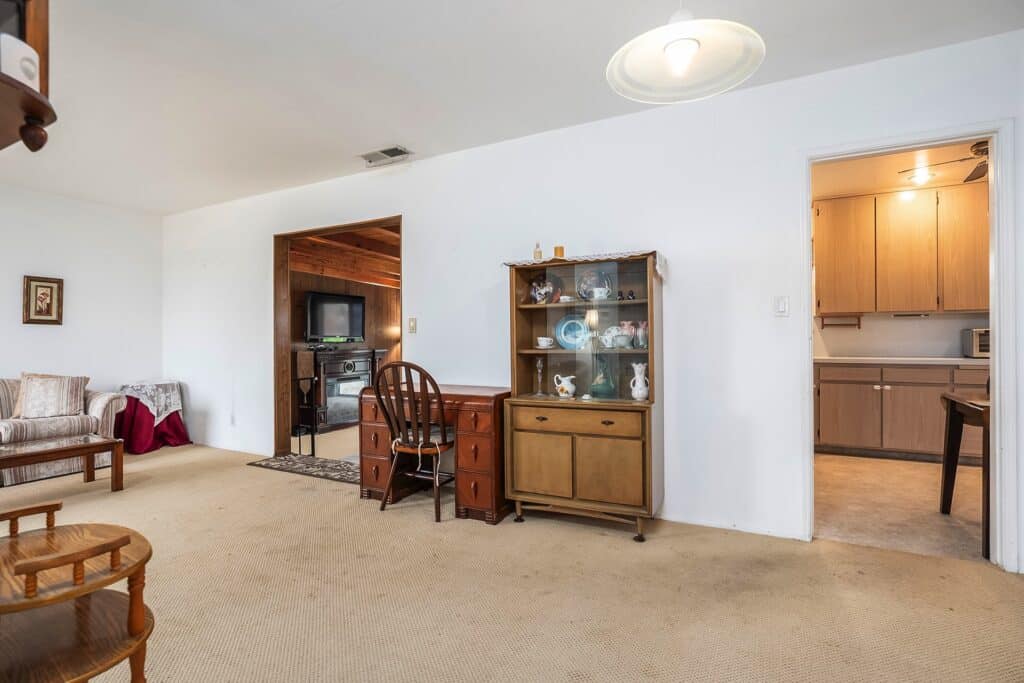 Dining area at 1751 39th St, San Diego, showing a vintage hutch and access to the functional kitchen