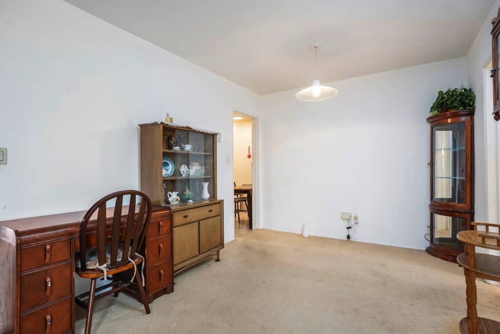 Dining area at 1751 39th St, San Diego, showing a vintage hutch and access to the functional kitchen