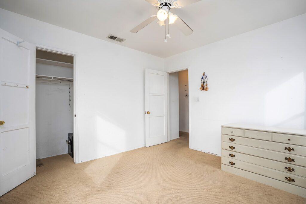 Bedroom at 1751 39th St, San Diego, featuring neutral carpet, a ceiling fan, and a spacious walk-in closet