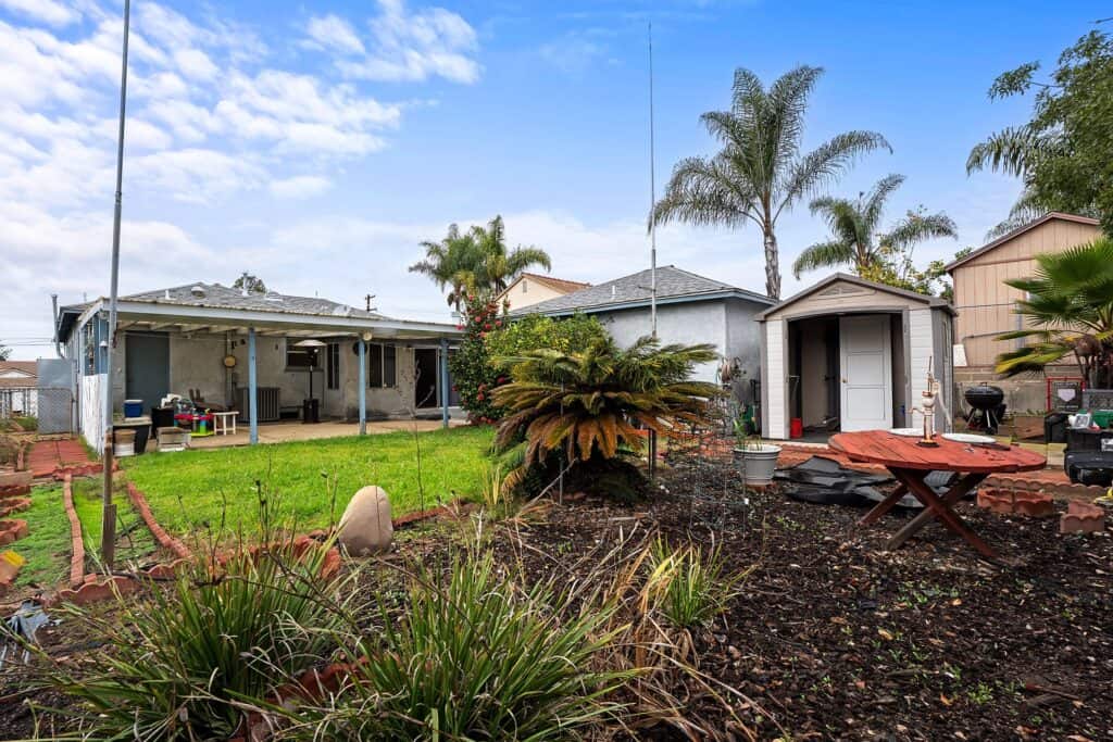 Lush private backyard at 1751 39th St, San Diego, featuring mature trees and a spacious covered patio for outdoor living