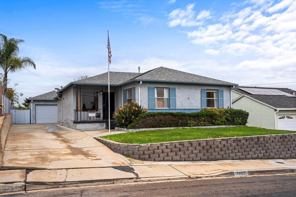 Exterior of a classic 1950s single-family home at 1751 39th Street in Fairmont Park San Diego, featuring a landscaped front lawn and long driveway.