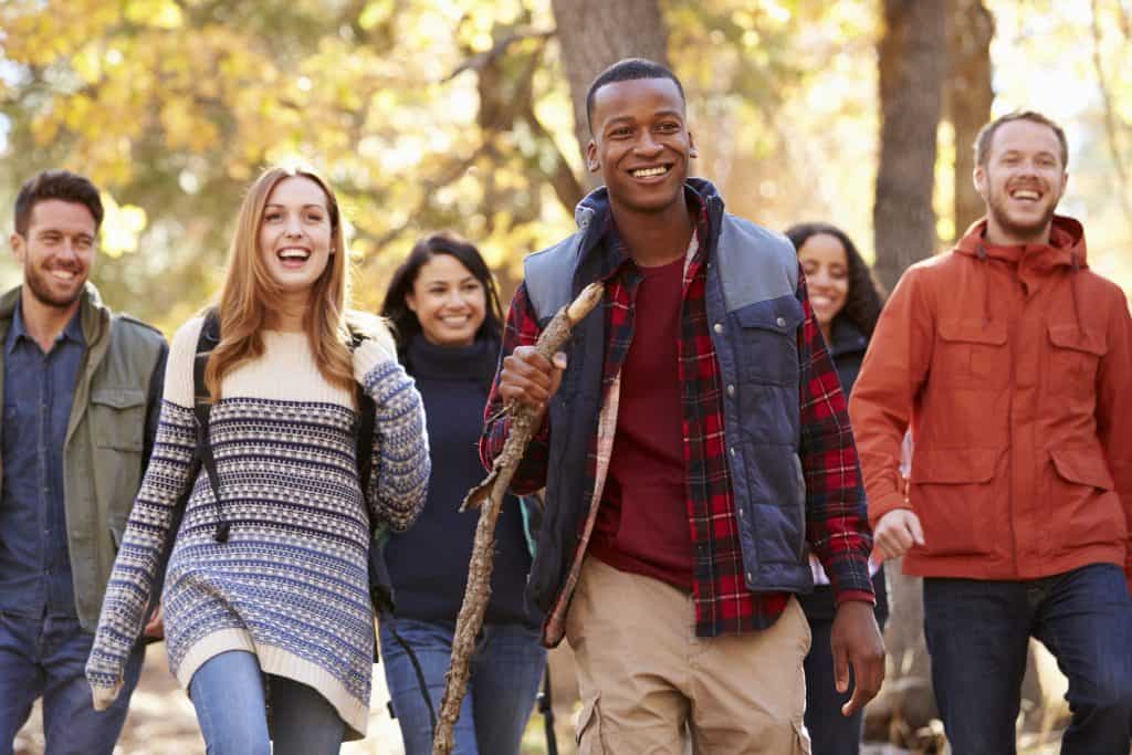 Group of people out on a hike in the woods.