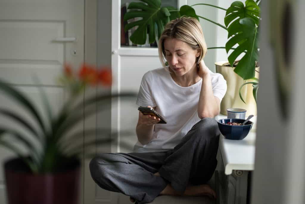 Woman wistfully scrolling through on online dating site wondering will I ever find true love...