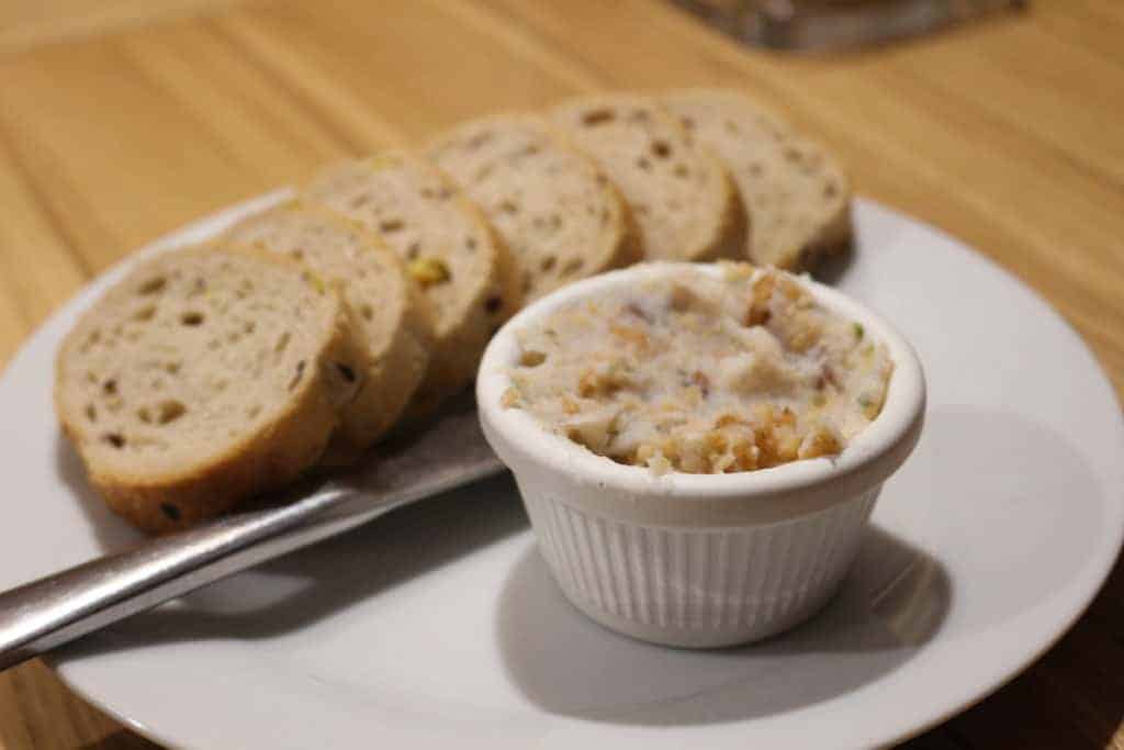 Pork lard in a small dish next to bread.