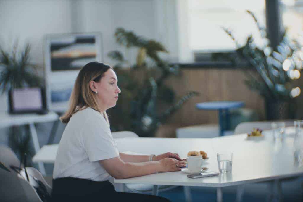 a woman in white T-shirt sitting