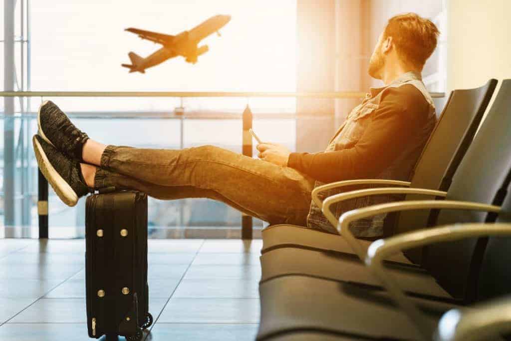 man waiting in an airport instead of taking flight