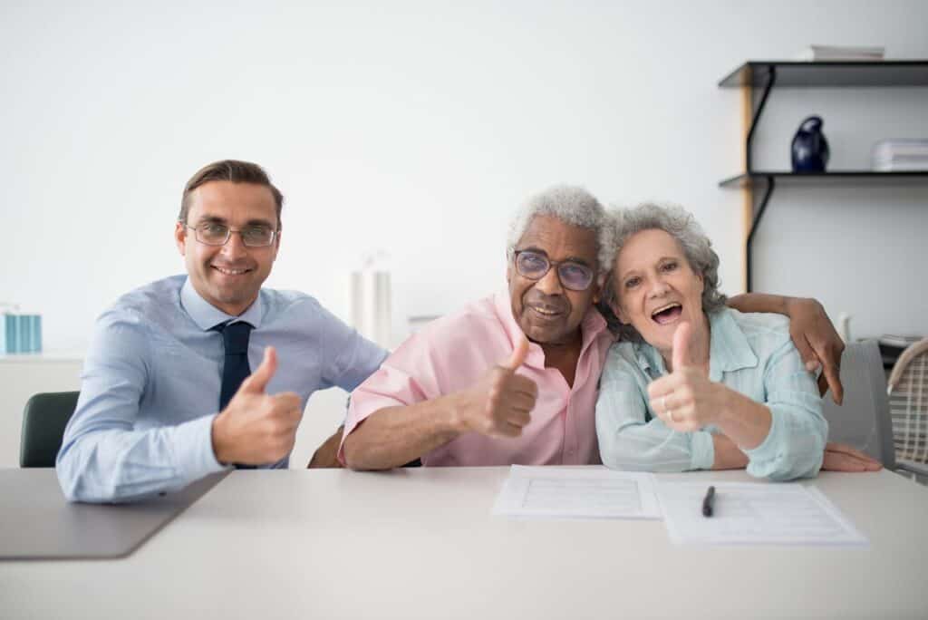 A Businessman with His Two Clients Doing a Thumbs Up