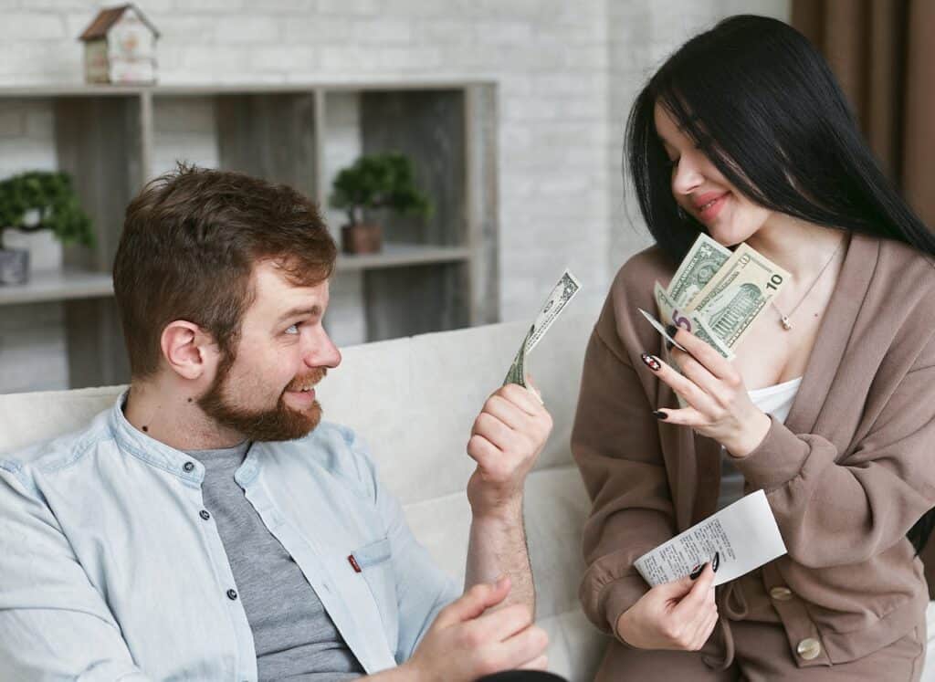 A Man and a Woman Holding Money
