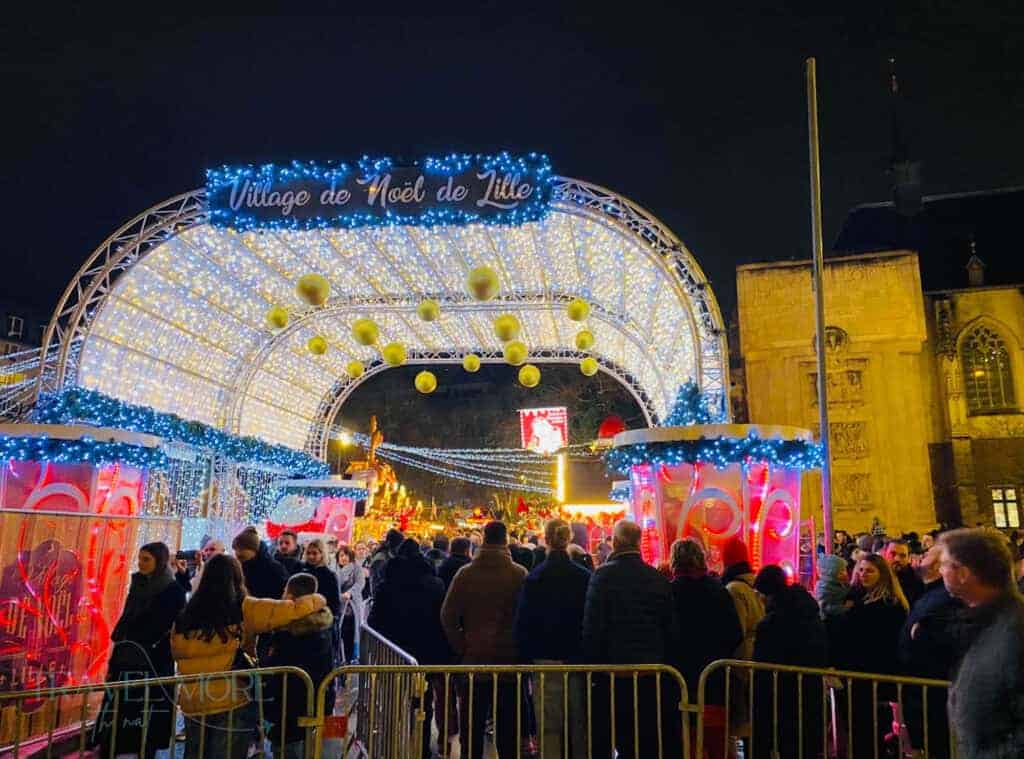 Festive lights illuminate crowded market.