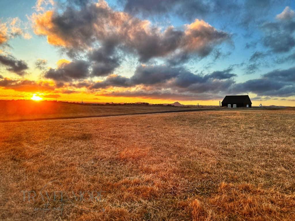 A golden sunset over a tranquil rural Iceland landscape. Staying outside of Reykyavik lets you be closer to nature.