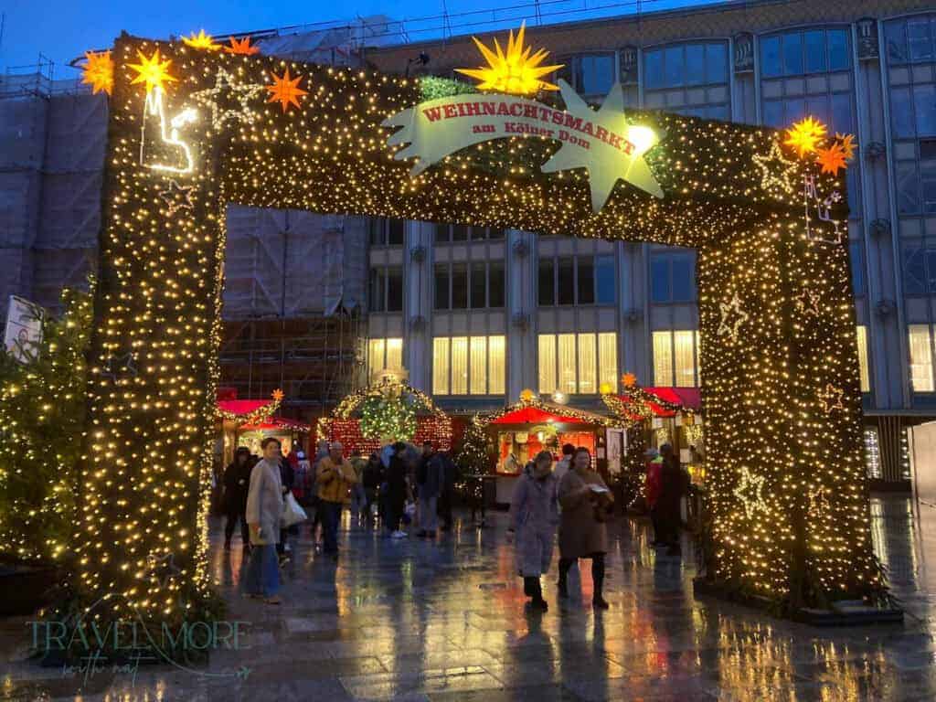 Festive market entrance adorned with lights.