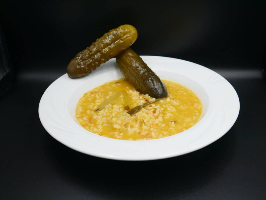 Ogorkowa soup with dill pickles in a bowl.