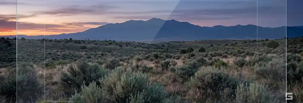 A twilight Northern New Mexico landscape viewed through a subtle glass overlay, representing high-level legal strategy for punitive damages. Grano Law Offices, P.C.