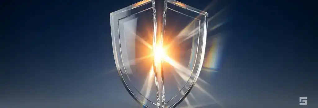 A fractured clear glass shield glowing with bright amber and white light on a dark navy blue background, representing the exposure of police misconduct. Strategic legal defense insights from Grano Law Offices, P.C.