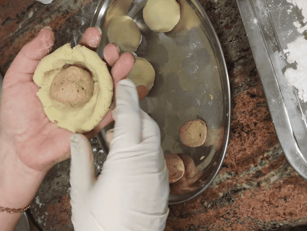 Add the minced meat balls to the dough.